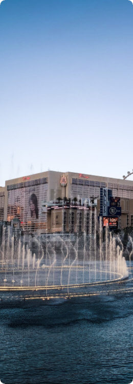 A fountain display in front of a hotel.